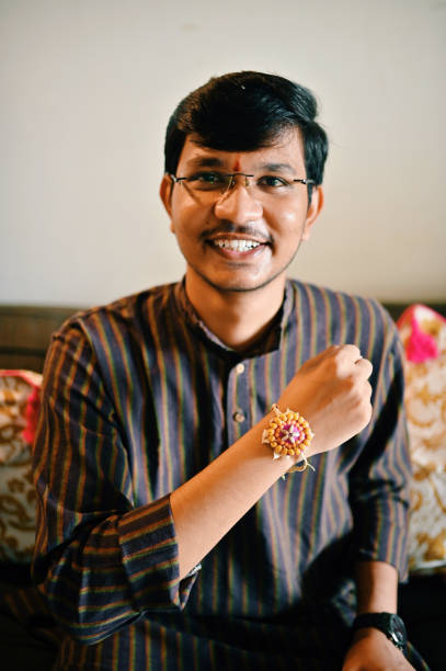 istock Young man showing his rakhi 1411047068