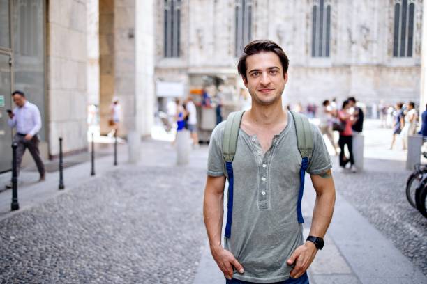 portrait of a smiling male tourist standing in front of a duomo in milan - foton med speaker bildbanksfoton och bilder