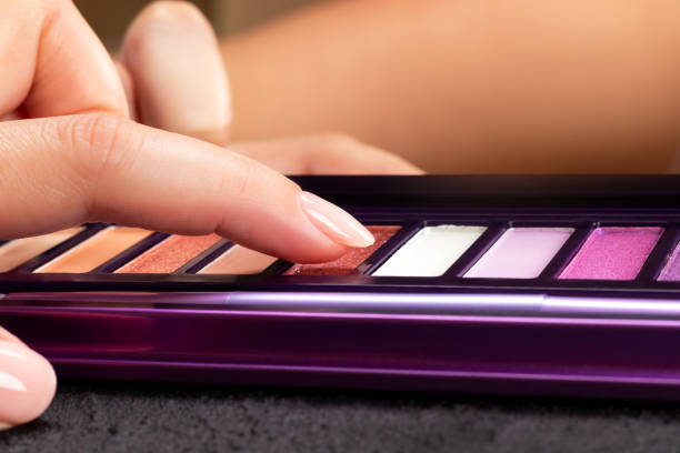 istock Female finger touching colorful eye shadow palette 1411050065