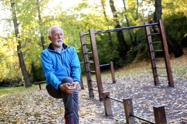 istock Senior man stretching in a park 1411050532