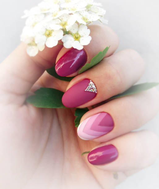 istock Female fingers with a beautiful abstract manicure 1411051594
