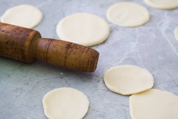 istock Preparing the dough for dumplings with blueberries. 1411053137