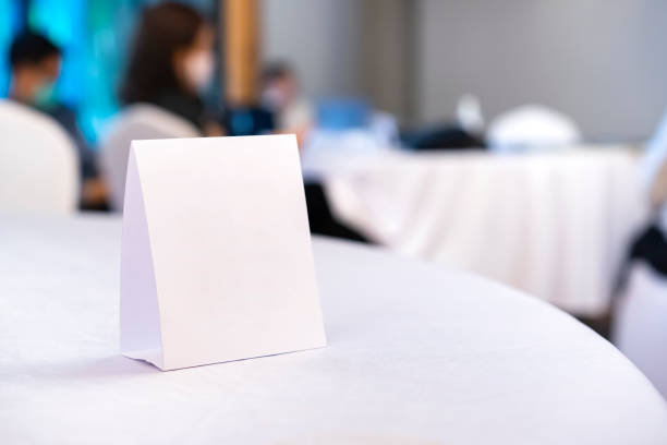 Triangular shaped table sign is placed on the table for scanning QR codes as an announcement, reservation sign, or menu at the seminar.