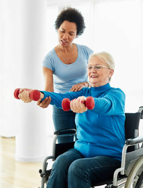 istock senior care exercise physical therapy exercising help assistence retirement home physiotherapy physiotherapist fitness gym strech band clinic therapist elderly woman band stretching 1411056130