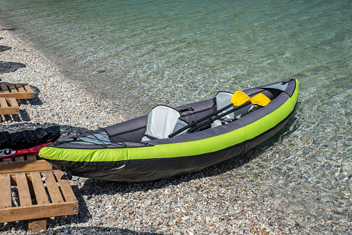 An inflatable canoe on the shore