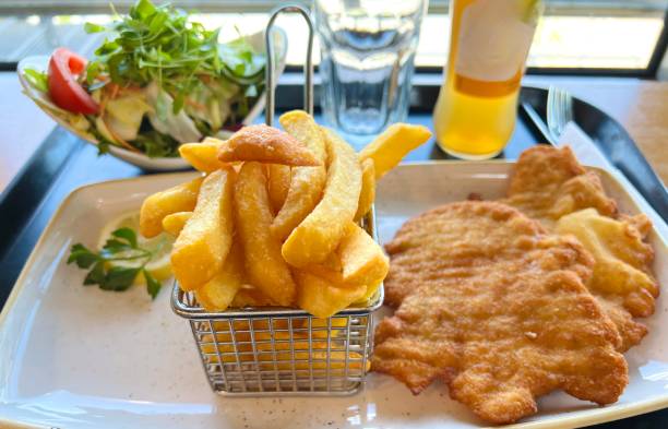 Breaded schnitzel, fries and salad, apple juice