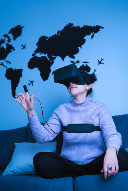 istock Woman wearing glasses and finger device for virtual reality simulation 1411058588