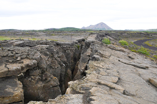 Crack in the rock with Grjotagja cave in the north of Iceland in the Myvatn area