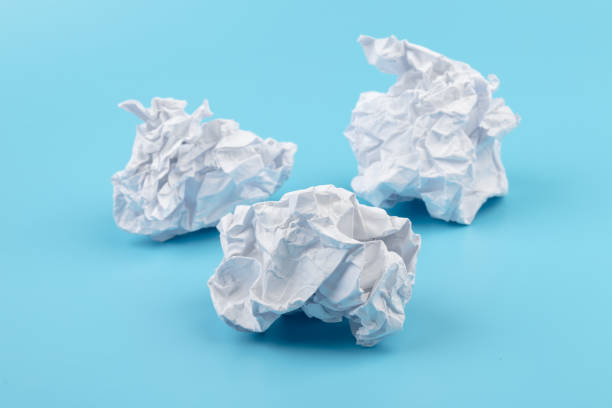 istock A piece of crumpled white paper on a blue background. 1411064260