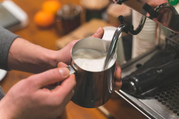 istock Frothing milk on a coffee machine stock photo 1411066294