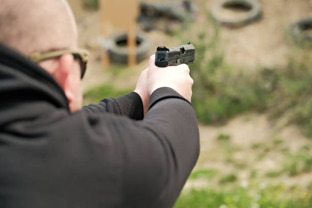 istock a man holds a gun in his hands. pistol shooting exercises 1411066681