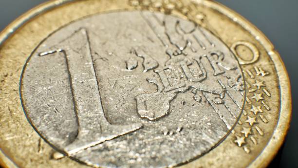 istock old worn one euro coin, close up 1411067889
