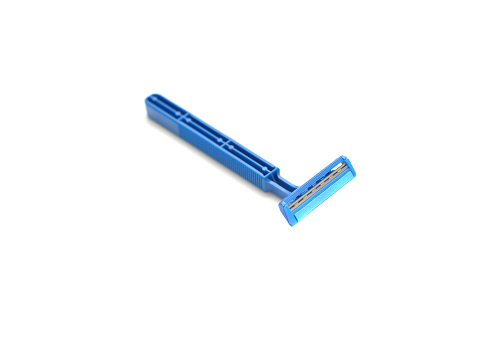 Closeup of a generic, mass produced blue razor on a white background.