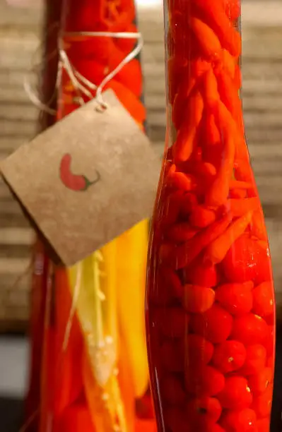 Photo of Handmade pepper in glass bottles for sale at a popular fair in Brazil.