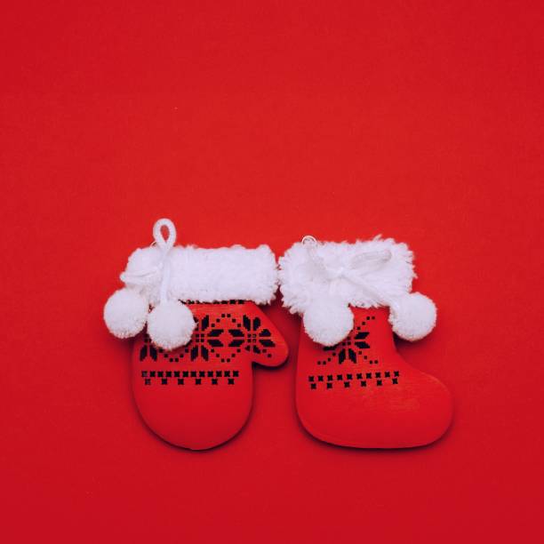 istock Festive decorative red Christmas Santa's mitten and boot on red background. Square Merry Christmas New Year greeting card. Flat lay with copy space 1411069884