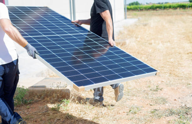 istock Workers charging solar panels. Alternative energy concept 1411071393