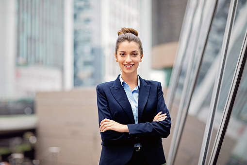 Portrait of young businesswoman at front of her office