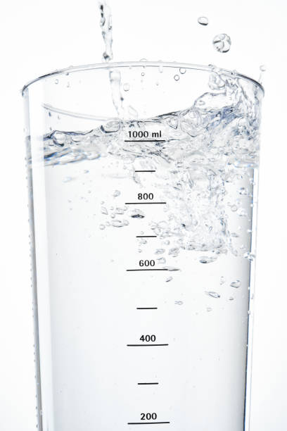 Stream of water  into a glass beaker.