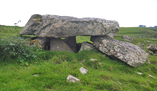 A dolmen is a type of single-chamber megalithic tomb, usually consisting of two or more vertical megaliths supporting a large flat horizontal capstone or \