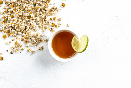 Camomile tea on white background. Directly above.