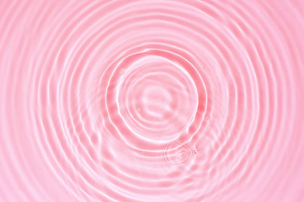 istock Abstract cosmetic background, pink water texture with round ripples, close up 1411077592
