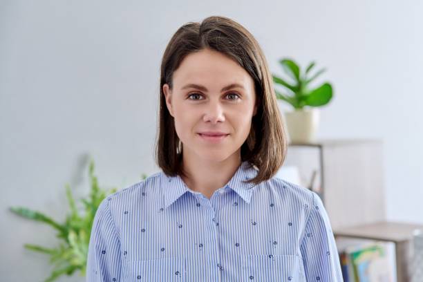 istock Headshot young smiling woman looking at camera in home interior 1411078594