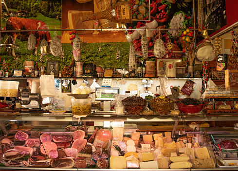 A typical Sicilian delicatessen called Salumeria with a large selection of hams and cheeses