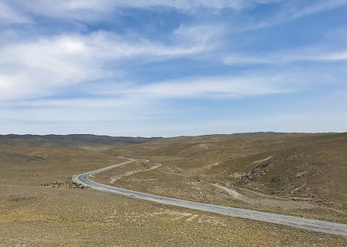 Open road. Top view of the steppe landscape with winding road between hills going beyond horizon. Beautiful nature landscape background. Copy space.