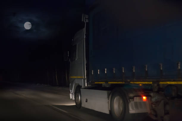 istock Truck move at night on highway on full moon. 1411081981
