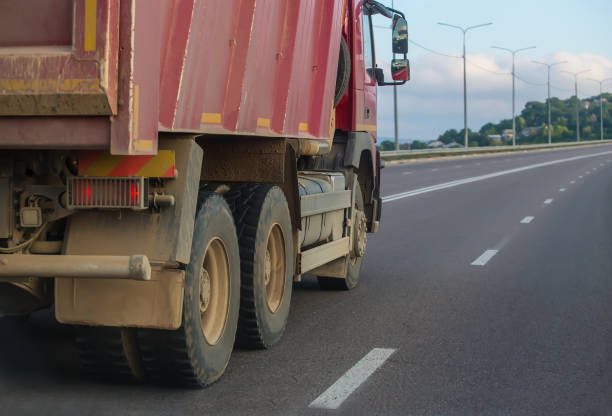 istock dump truck moves along a country road 1411082021