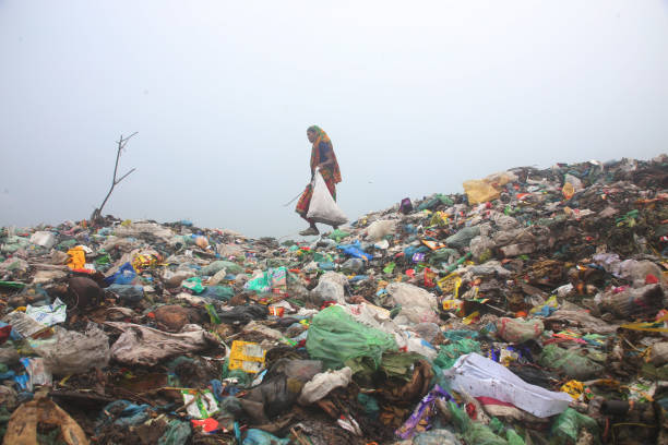 A woman worker collects plastic waste from the garbage heap for sale. on June 7, 2022, Sylhet, Bangladesh.