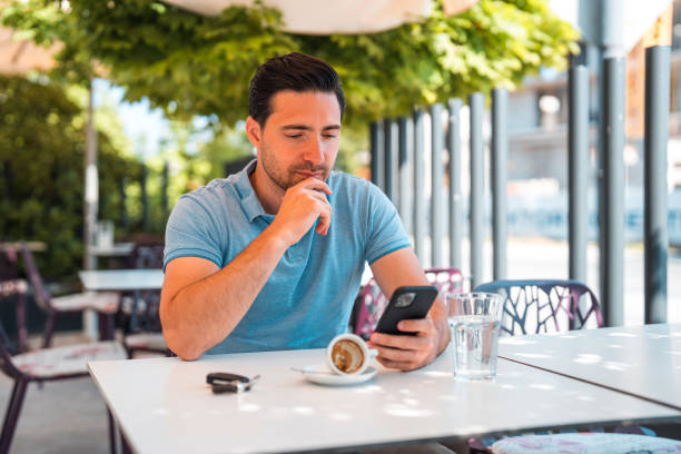 istock Young Handsome Man Reading Emails With His Smart Phone 1411083718