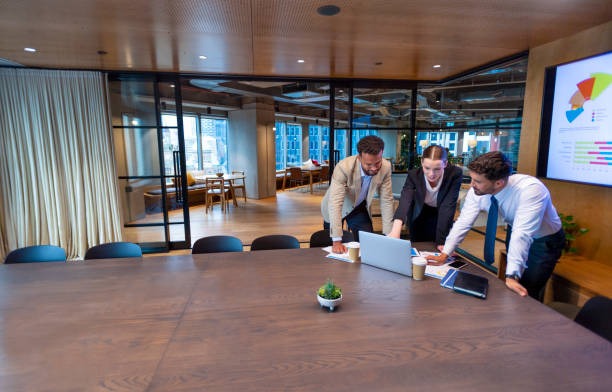 istock Business people working on a laptop computer in a modern office 1411083837
