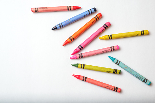 Close-up of colored pencils on white background with copy space