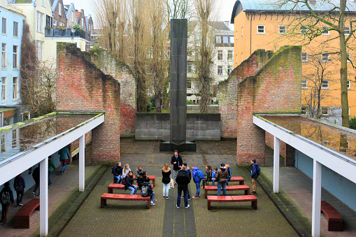 Amsterdam, Netherlands: visitors learn about the Shoah at the column of the Dutch Holocaust Memorial - 75% of the Dutch-Jewish population was murdered in the Holocaust - The German occupation forces estimated the number of  Dutch Jews in 1941 at 154,000, in the German census, 121,000 persons were Ashkenazi and 4,300 persons were members of the (Sephardic) Portuguese-Israelite community - Jewish Cultural Quarter.