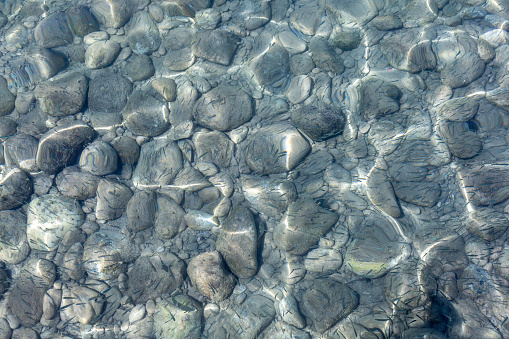 View of underwater pebbles in the sea, pebble background.