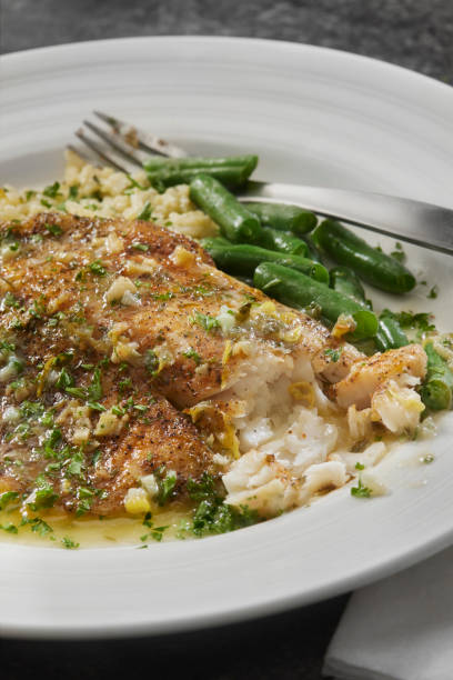dish of sole fish with eggs and fusilli and cauliflower close up