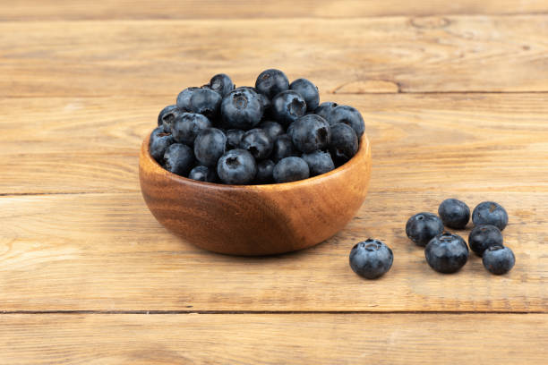istock Blueberries on a wooden background with space for text. 1411092007