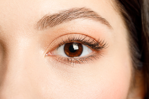 Macro shot of female eye, iris, cropped on black background, usable as creative background