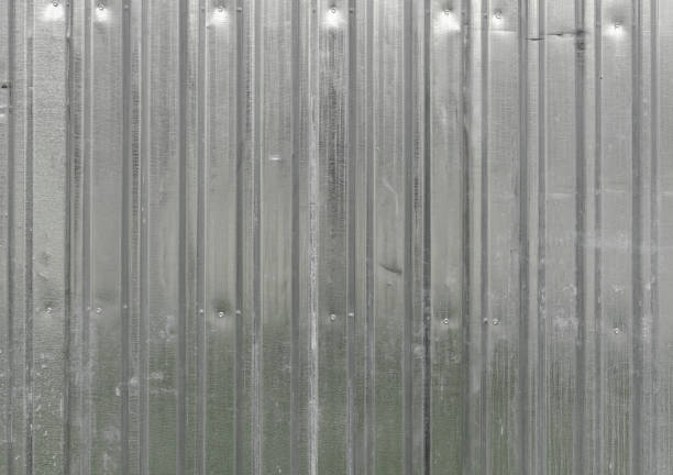 The texture of the fence made of green profiled sheet. Background. Space for text. Texture of iron metal industrial tin white sheet metal profile with vertical boards for the fence. The background. corrugated metal fence ideas stock pictures, royalty-free photos & images