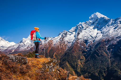 Female trekker in Mount Everest National Park. This is the highest national park in the world, with the entire park located above 3,000 m ( 9,700 ft). This park includes three peaks higher than 8,000 m, including Mt Everest.