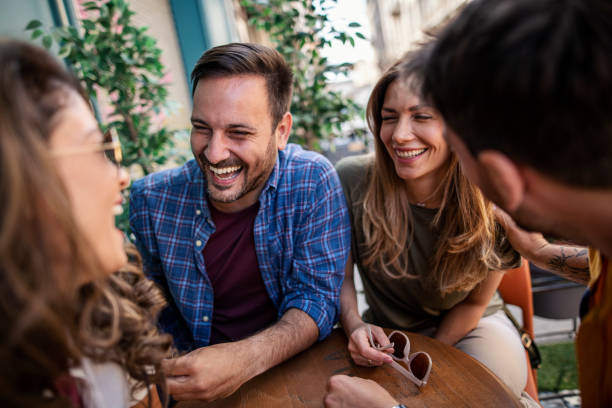 Group of friends enjoying time together in a sidewalk cafe stock photo