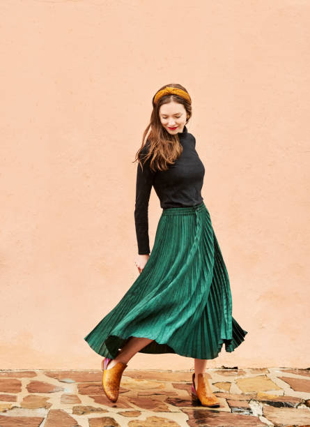 istock Stylish young woman walking outside 1411104614