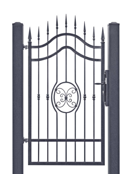 istock Forged decorative wrought iron pedestrian entrance wicket gate, isolated vertical large detailed dark grey silhouette closeup, closed wrought iron fleur-de-lis lattice, white background 1411106186