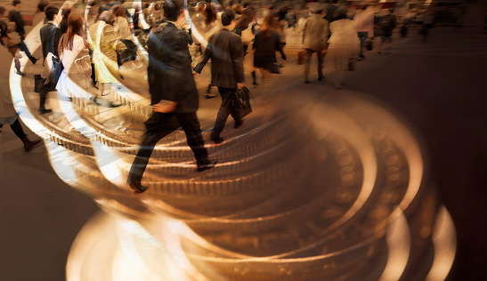 digital composite images of city commuters and  stack of coins