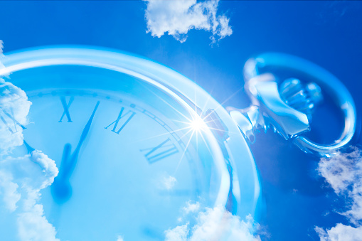 digital composite images of pocket watch and  cloudscape with sunlight