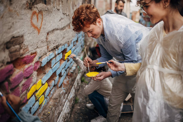 istock Street artists drawing on wall 1411106493