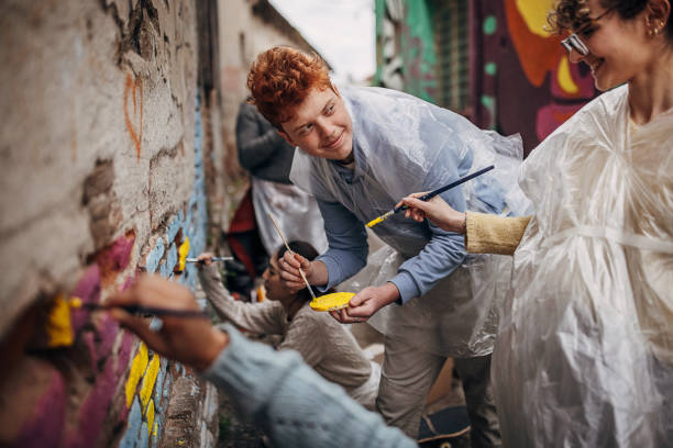 istock Street artists drawing on wall 1411106516