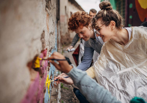 istock Street artists drawing on wall 1411106548