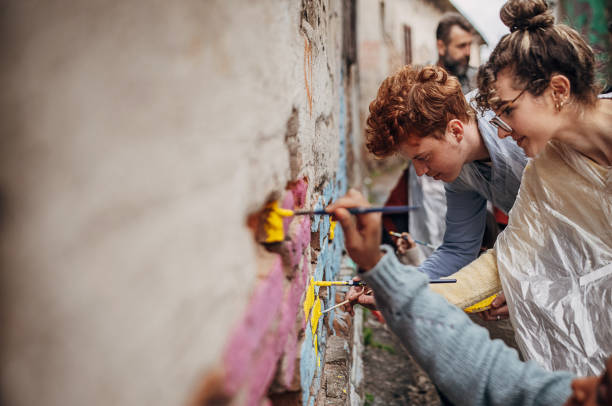 Street artists drawing on wall